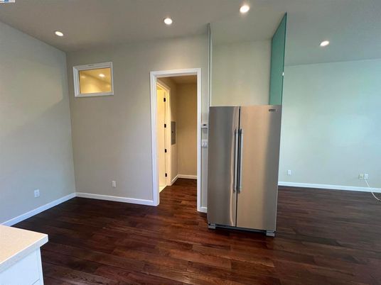 Empty room, Interior, Kitchen, Recessed Lighting, Stainless Steel Appliances, Wood Texture Flooring