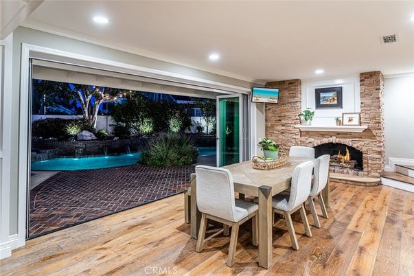 Dining room, Fireplace, Interior, Recessed Lighting, Stone Walls, Wood Texture Flooring