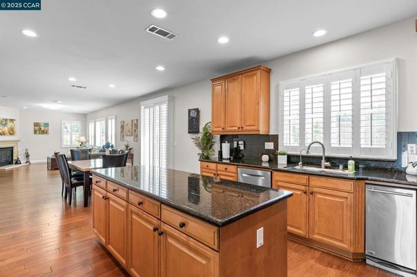 Dining room, Fireplace, Interior, Kitchen, Recessed Lighting, Stainless Steel Appliances, Wood Texture Flooring