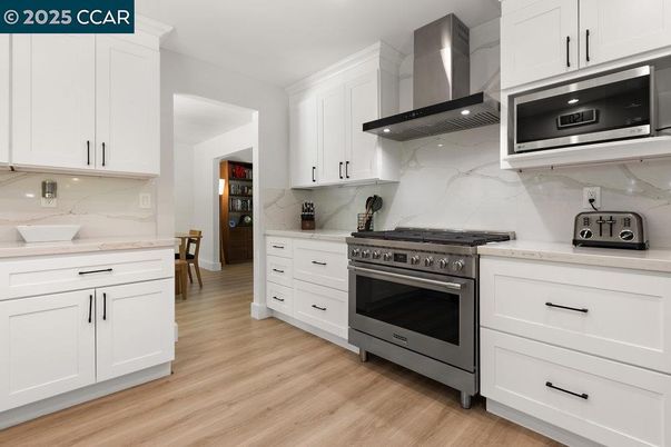 Interior, Kitchen, Marble Walls, Recessed Lighting, Stainless Steel Appliances, Wood Texture Flooring