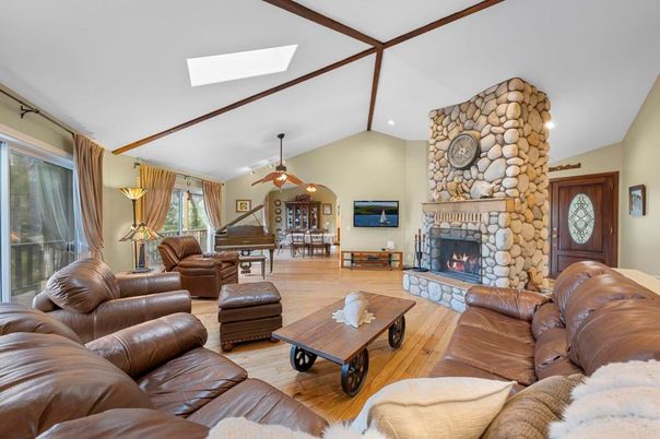 Fireplace, Interior, Living room, Piano, Recessed Lighting, Stone Walls, Wood Texture Flooring