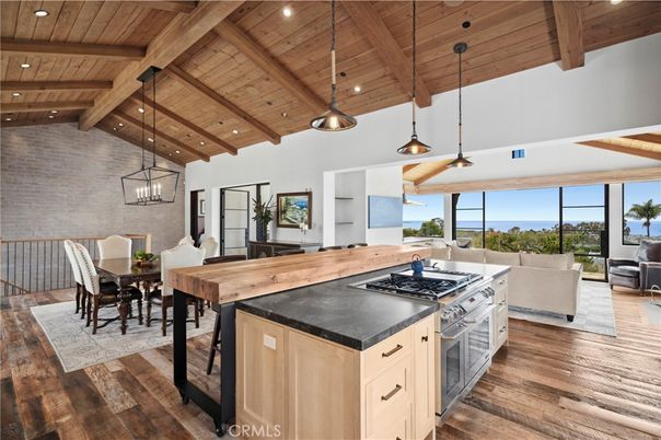 Dining room, Interior, Kitchen, Living room, Pendant Lights, Recessed Lighting, Stainless Steel Appliances, Water, Wooden Beams, Wooden Ceilings, Wood Texture Flooring