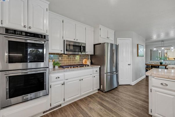 Interior, Kitchen, Pendant Lights, Stainless Steel Appliances, Tile Countertops, Wood Texture Flooring