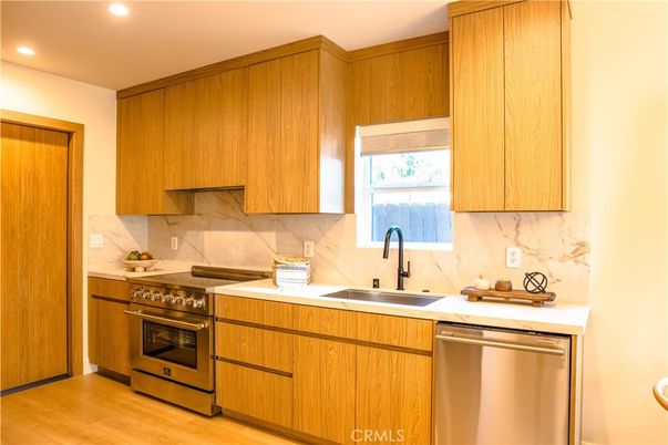 Interior, Kitchen, Marble Walls, Recessed Lighting, Stainless Steel Appliances, Wood Texture Flooring