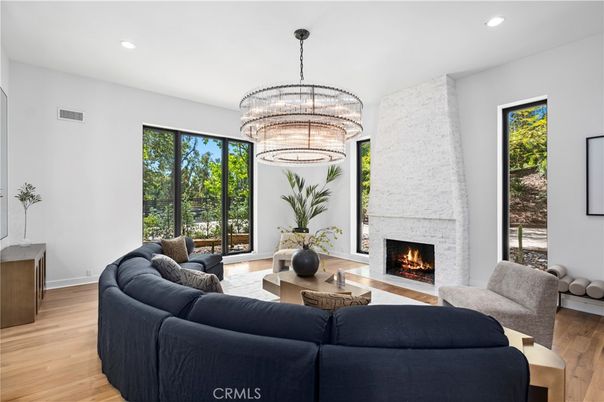 Chandelier, Fireplace, Interior, Living room, Recessed Lighting, Stone Walls, Wood Texture Flooring