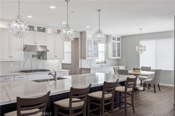 Chandelier, Dining room, Interior, Kitchen, Pendant Lights, Recessed Lighting, Stainless Steel Appliances, Wood Texture Flooring