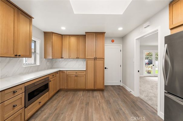 Interior, Kitchen, Marble Walls, Recessed Lighting, Stainless Steel Appliances, Wood Texture Flooring