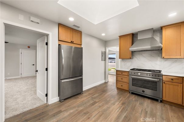 Interior, Kitchen, Marble Walls, Recessed Lighting, Stainless Steel Appliances, Wood Texture Flooring