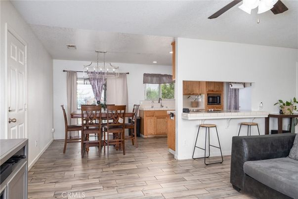 Dining room, Interior, Kitchen, Pendant Lights, Recessed Lighting, Stainless Steel Appliances, Wood Texture Flooring