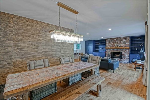 Chandelier, Dining room, Fireplace, Interior, Living room, Pendant Lights, Recessed Lighting, Stone Walls, Wood Texture Flooring