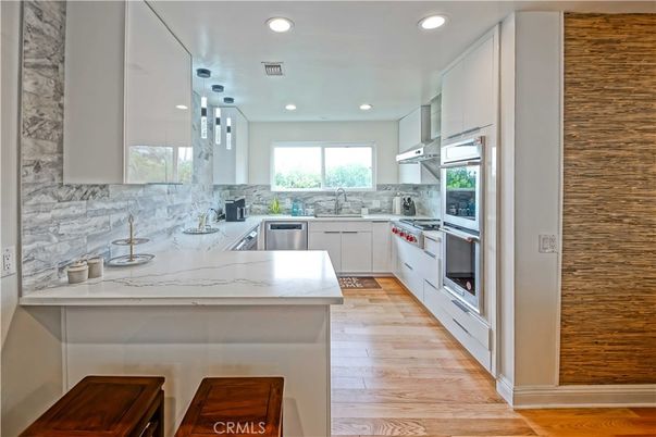 Interior, Kitchen, Marble Walls, Pendant Lights, Recessed Lighting, Stainless Steel Appliances, Wood Texture Flooring