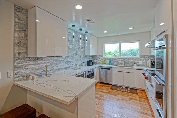 Interior, Kitchen, Marble Walls, Pendant Lights, Recessed Lighting, Stainless Steel Appliances, Wood Texture Flooring