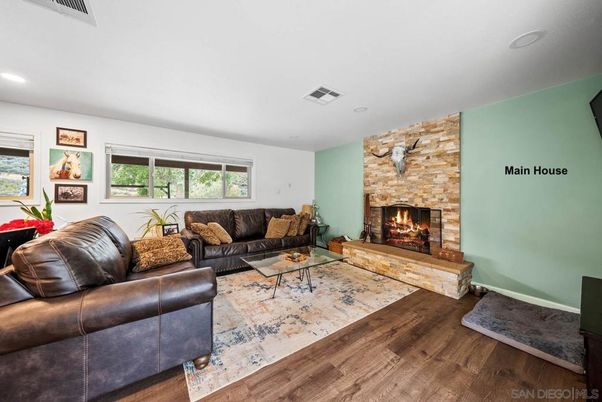 Fireplace, Interior, Living room, Recessed Lighting, Stone Walls, Wood Texture Flooring
