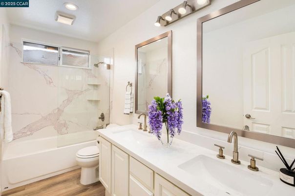 Bathroom, Dual Sink Vanities, Interior, Marble Walls, Recessed Lighting, Wood Texture Flooring