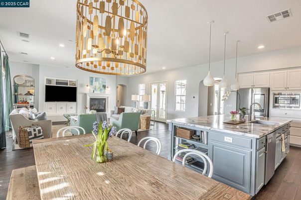 Chandelier, Dining room, Fireplace, Interior, Kitchen, Living room, Pendant Lights, Recessed Lighting, Stainless Steel Appliances, Wood Texture Flooring