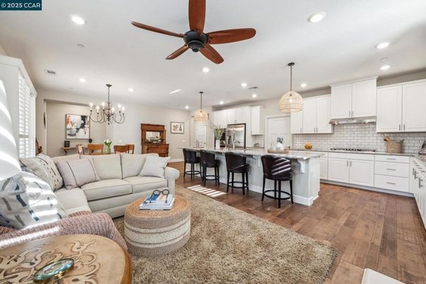 Chandelier, Dining room, Interior, Kitchen, Living room, Pendant Lights, Recessed Lighting, Stainless Steel Appliances, Wood Texture Flooring