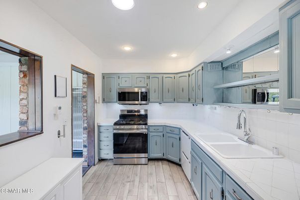 Interior, Kitchen, Recessed Lighting, Stainless Steel Appliances, Tile Countertops, Wood Texture Flooring