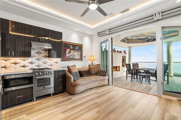 Dining room, Fireplace, Interior, Kitchen, Recessed Lighting, Stainless Steel Appliances, Water, Wood Texture Flooring