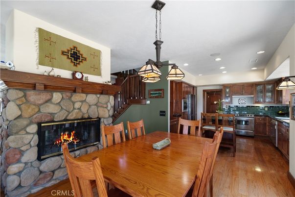 Dining room, Fireplace, Interior, Kitchen, Pendant Lights, Recessed Lighting, Stainless Steel Appliances, Stone Walls, Wood Texture Flooring