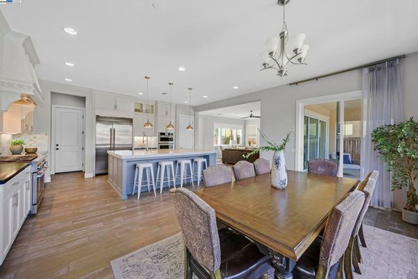 Chandelier, Dining room, Interior, Kitchen, Pendant Lights, Recessed Lighting, Stainless Steel Appliances, Wood Texture Flooring