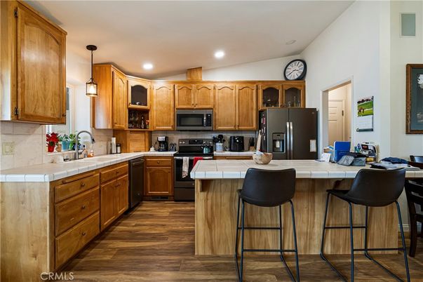 Interior, Kitchen, Pendant Lights, Recessed Lighting, Stainless Steel Appliances, Tile Countertops, Wood Texture Flooring