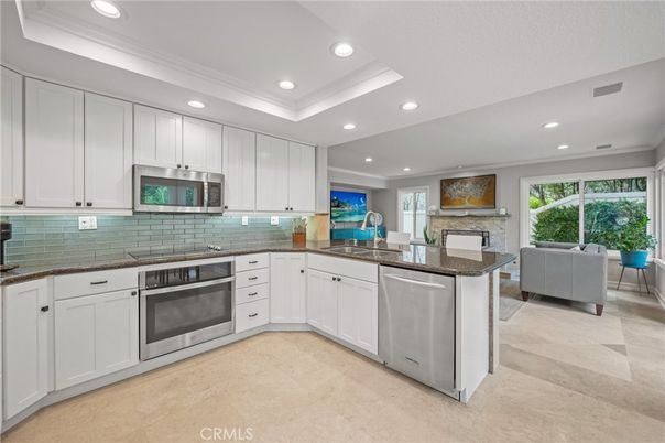 Fireplace, Interior, Kitchen, Living room, Recessed Lighting, Stainless Steel Appliances, Stone Walls