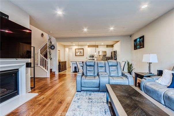 Fireplace, Interior, Kitchen, Living room, Pendant Lights, Recessed Lighting, Stainless Steel Appliances, Wood Texture Flooring