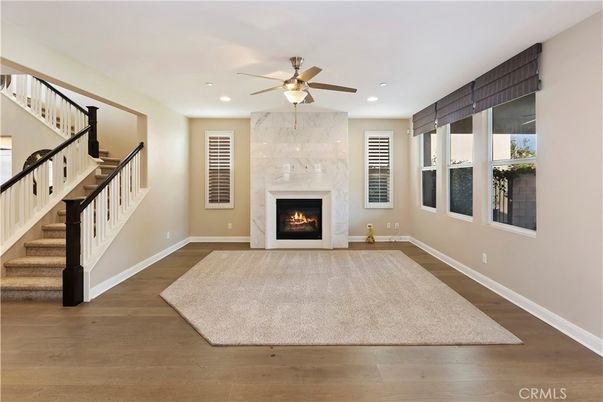 Fireplace, Interior, Marble Walls, Recessed Lighting, Wood Texture Flooring