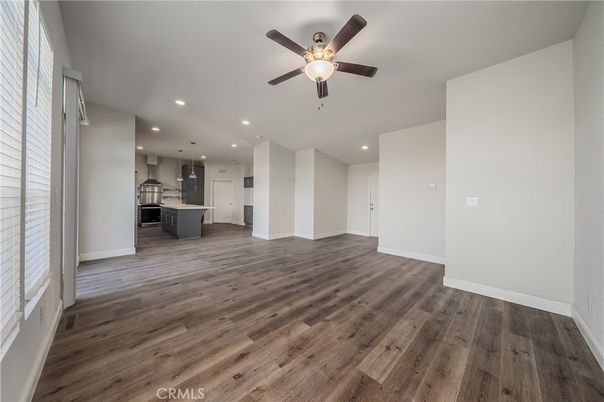 Empty room, Interior, Kitchen, Recessed Lighting, Stainless Steel Appliances, Wood Texture Flooring