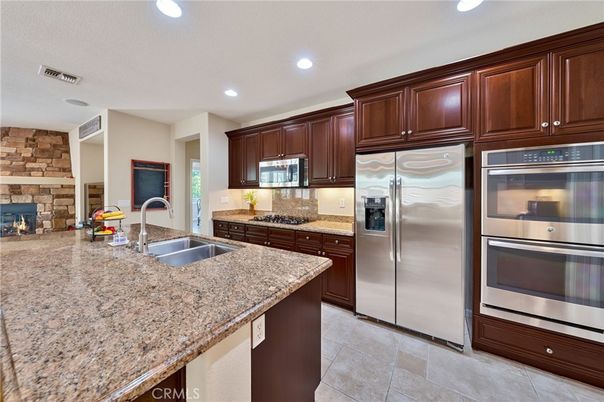 Fireplace, Interior, Kitchen, Recessed Lighting, Stainless Steel Appliances, Stone Walls