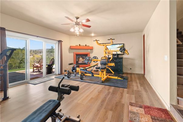 Fireplace, Fitness Equipment, Interior, Recessed Lighting, Wood Texture Flooring