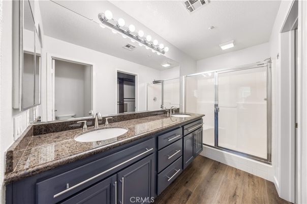 Bathroom, Dual Sink Vanities, Glass Shower, Interior, Recessed Lighting, Wood Texture Flooring
