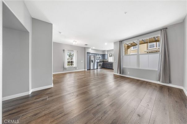 Empty room, Interior, Kitchen, Recessed Lighting, Stainless Steel Appliances, Wood Texture Flooring