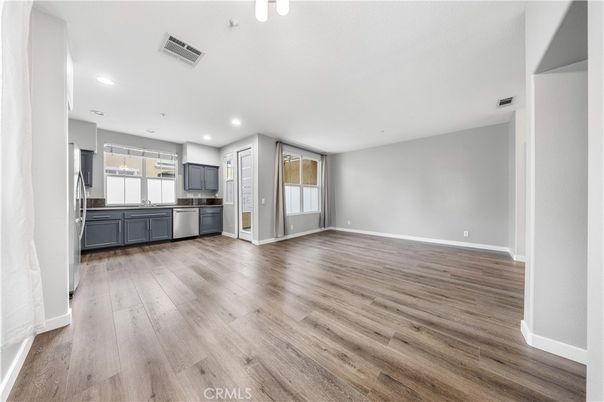 Empty room, Interior, Kitchen, Recessed Lighting, Stainless Steel Appliances, Wood Texture Flooring