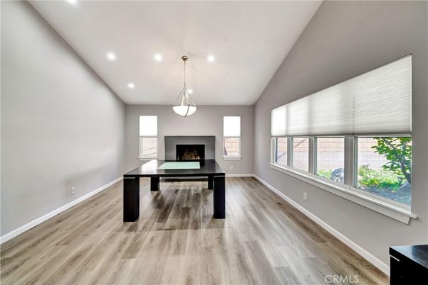 Fireplace, Game Room, Interior, Pendant Lights, Recessed Lighting, Wood Texture Flooring