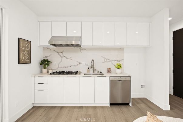 Interior, Kitchen, Marble Walls, Recessed Lighting, Stainless Steel Appliances, Wood Texture Flooring