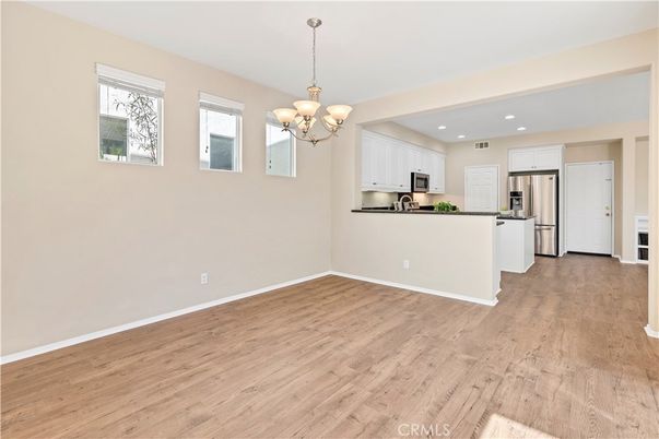 Chandelier, Empty room, Interior, Kitchen, Recessed Lighting, Stainless Steel Appliances, Wood Texture Flooring