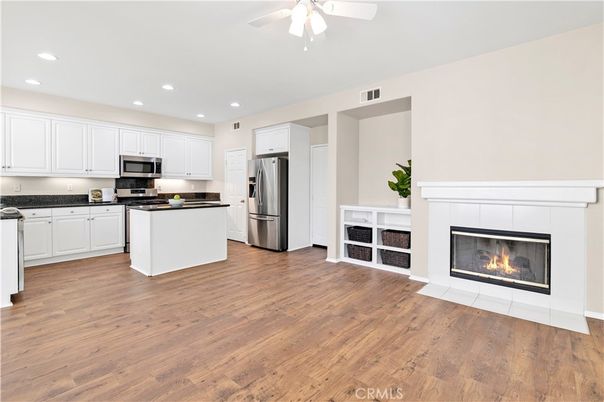 Fireplace, Interior, Kitchen, Recessed Lighting, Stainless Steel Appliances, Wood Texture Flooring