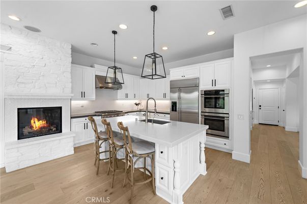 Fireplace, Interior, Kitchen, Pendant Lights, Recessed Lighting, Stainless Steel Appliances, Wood Texture Flooring