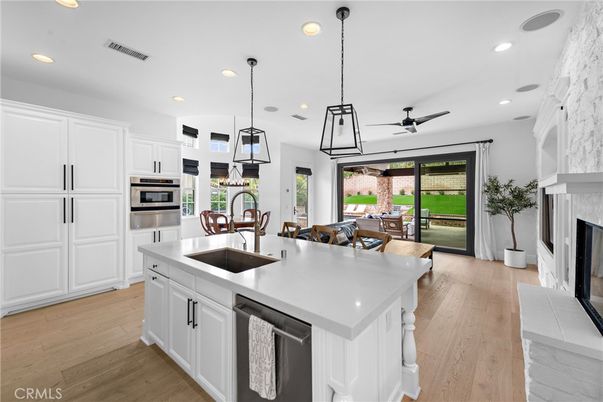 Dining room, Fireplace, Interior, Kitchen, Pendant Lights, Recessed Lighting, Stainless Steel Appliances, Wood Texture Flooring
