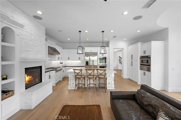 Fireplace, Interior, Kitchen, Living room, Pendant Lights, Recessed Lighting, Stainless Steel Appliances, Wood Texture Flooring