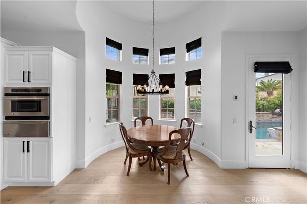 Chandelier, Dining room, Interior, Kitchen, Pendant Lights, Stainless Steel Appliances, Wood Texture Flooring