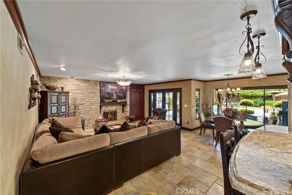 Chandelier, Dining room, Fireplace, Interior, Living room, Pendant Lights, Stone Walls