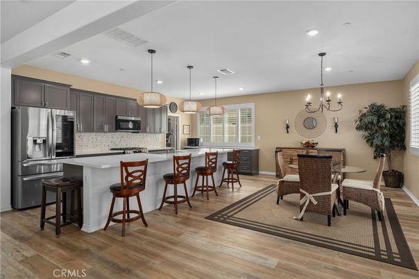 Chandelier, Dining room, Interior, Kitchen, Pendant Lights, Recessed Lighting, Stainless Steel Appliances, Wood Texture Flooring