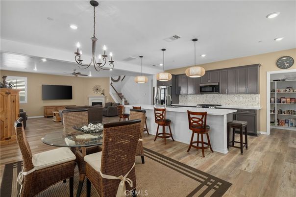 Chandelier, Dining room, Interior, Kitchen, Pendant Lights, Recessed Lighting, Stainless Steel Appliances, Wood Texture Flooring