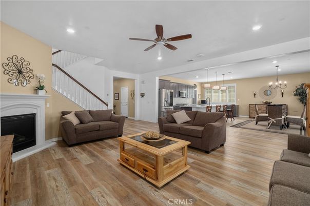 Chandelier, Dining room, Fireplace, Interior, Kitchen, Living room, Pendant Lights, Recessed Lighting, Stainless Steel Appliances, Wood Texture Flooring