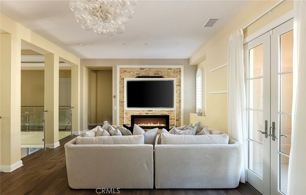 Chandelier, Fireplace, Interior, Living room, Recessed Lighting, Stone Walls, Wood Texture Flooring