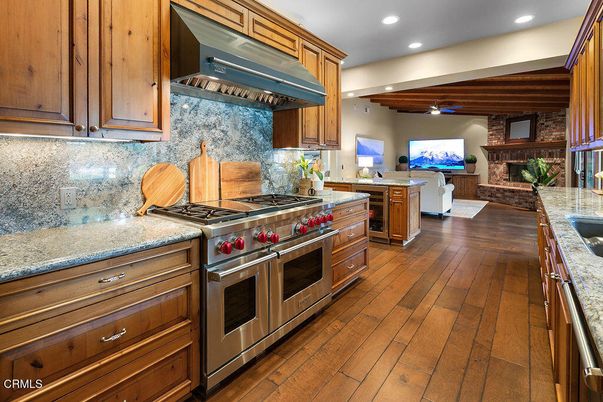 Fireplace, Interior, Kitchen, Recessed Lighting, Stainless Steel Appliances, Stone Walls, Wood Texture Flooring