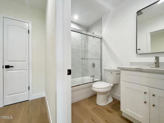Bathroom, Glass Shower, Interior, Marble Walls, Recessed Lighting, Wood Texture Flooring