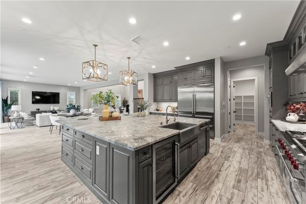 Chandelier, Interior, Kitchen, Living room, Pendant Lights, Recessed Lighting, Stainless Steel Appliances, Wood Texture Flooring